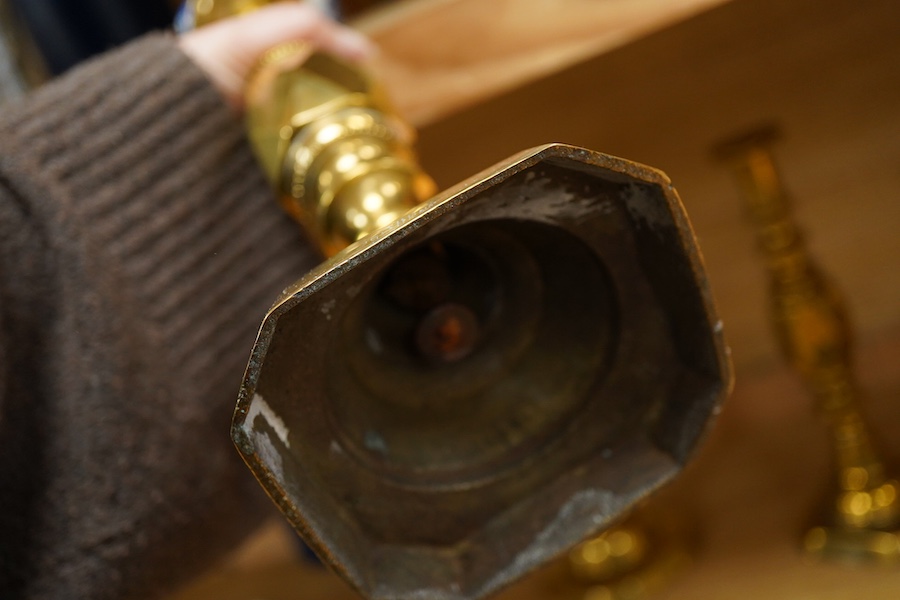 A group of copper and brassware to include candlesticks and an alms dish, 45cm in diameter